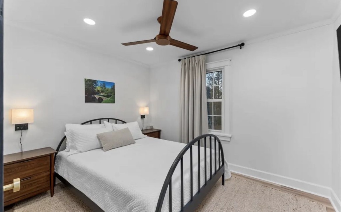 Second bedroom with queen bed, black metal frame, twin nightstands and lamps