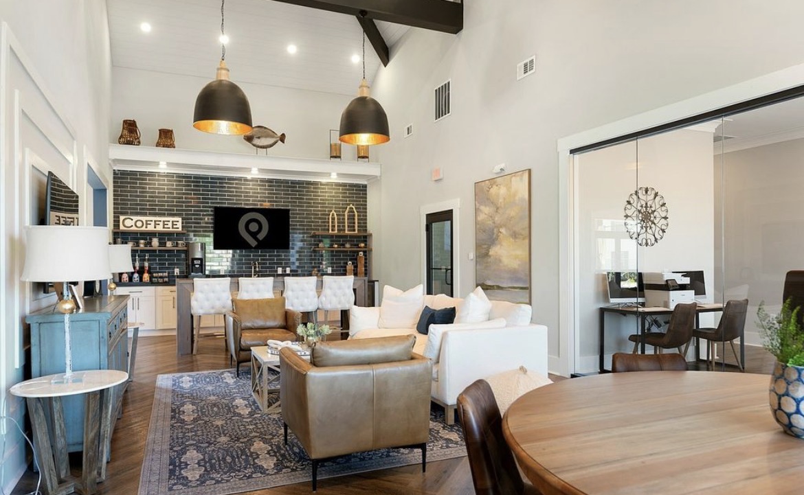 Clubhouse lounge with vaulted ceiling, leather seating and pendant lights