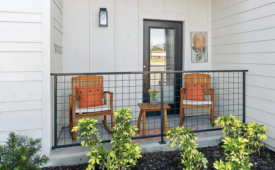 Front porch with two wooden rocking chairs and side table